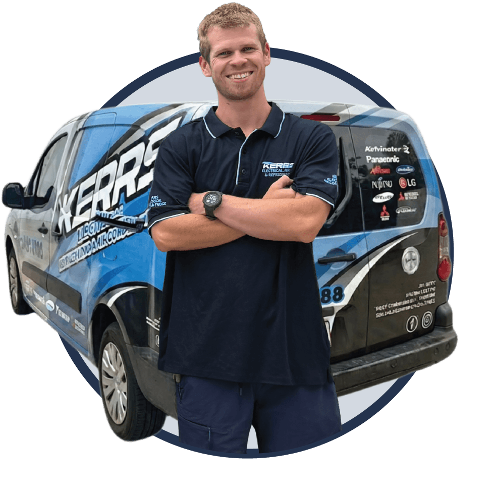 A man in a navy blue Kerr's Electrical polo shirt stands smiling with arms crossed in front of a blue and white Kerr's Electrical van.